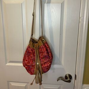 COOGI Red Faux leather multi color print brown trim bucket style shoulder bag.